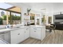 Modern kitchen with white cabinets, quartz countertops, and stainless steel appliances at 6757 E Paradise Ln, Scottsdale, AZ 85254