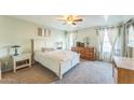 Bright bedroom with a white bed and wooden dresser at 2221 E Frye Rd, Chandler, AZ 85225