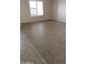 Living room with tile flooring and large window at 21657 N Dietz Dr, Maricopa, AZ 85138