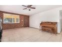 Living room with tiled floors and wood paneled walls at 7340 W Glenrosa Ave, Phoenix, AZ 85033