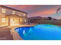 Relaxing freeform pool with patio furniture and outdoor bar at 2660 S 172Nd Dr, Goodyear, AZ 85338