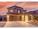Two-story house with a two-car garage, arched entryway and desert landscaping at 2660 S 172Nd Dr, Goodyear, AZ 85338