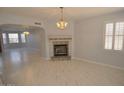 Living room with tile floors, fireplace, and chandelier at 18071 W Douglas Way, Surprise, AZ 85374