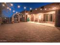 Inviting front porch with string lights, rocking chairs, and large planters at 15339 E Red Bird Rd, Scottsdale, AZ 85262