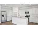 Bright kitchen with white cabinets, large island, and stainless steel appliances at 9911 S Caballo Dr, Apache Junction, AZ 85120