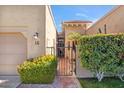 Neat and inviting exterior of a condo with a private gate and well-maintained landscaping at 7318 E Palo Verde Dr # 16, Scottsdale, AZ 85250