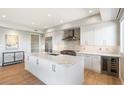 Modern kitchen with white cabinets, large island, and stainless steel appliances at 16580 N 92Nd St # 2001, Scottsdale, AZ 85260