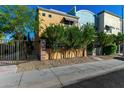 This two-story home features brick accents, professional landscaping, and a gated entry at 1406 W Main St # 137, Mesa, AZ 85201