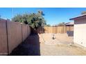Small backyard with block wall and wooden fence at 9618 N 66 Dr, Glendale, AZ 85302