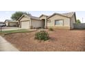 Single-story house with a well-maintained front yard and a two-car garage at 810 E Yanez Ave, Buckeye, AZ 85326