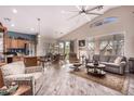 Open floor plan living room with hardwood floors and a ceiling fan at 18478 N Canal Dr, Surprise, AZ 85374