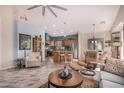 Open concept living room, kitchen, and dining area with tile floors at 18478 N Canal Dr, Surprise, AZ 85374