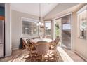 Cozy breakfast nook with a round table and chairs, adjacent to sliding doors at 18478 N Canal Dr, Surprise, AZ 85374