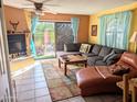 Cozy living room featuring a fireplace and access to a patio at 12851 N Mimosa Dr # 101, Fountain Hills, AZ 85268