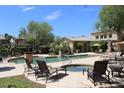 Community pool and spa with lounge chairs at 16013 S Desert Foothills Pkwy # 1101, Phoenix, AZ 85048