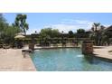 Inviting community pool with a waterfall feature and lounge chairs at 16013 S Desert Foothills Pkwy # 1101, Phoenix, AZ 85048