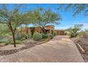 Spanish style home with landscaped yard and a long driveway at 38800 N 107Th Way, Scottsdale, AZ 85262