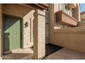 View of the home's entrance with a green door and columned entryway at 839 S Westwood -- # 182, Mesa, AZ 85210