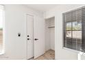 Bright entryway with white door, coat closet, and wood-look flooring at 839 S Westwood -- # 182, Mesa, AZ 85210