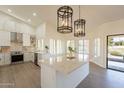 Bright kitchen, features white cabinets, marble island, and high-end appliances at 19832 N 95Th Ave, Peoria, AZ 85382