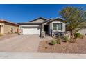 Single-story home with white garage door and stone accents at 13384 W Red Range Way, Peoria, AZ 85383