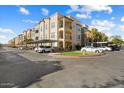 Building exterior with parking and landscaping at 14575 W Mountain View Blvd # 11312, Surprise, AZ 85374