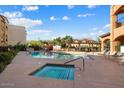 Community pool and spa with lounge chairs at 14575 W Mountain View Blvd # 11312, Surprise, AZ 85374
