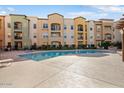 Community pool and spa with surrounding building at 14575 W Mountain View Blvd # 11312, Surprise, AZ 85374