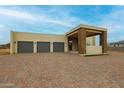 Modern three-car garage home with stone accents and a large driveway at 14930 W El Cortez Pl, Surprise, AZ 85387