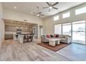 Open-concept living area with kitchen, island, and access to backyard at 11702 W Delwood Dr, Arizona City, AZ 85123