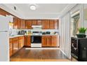 Bright kitchen featuring wood cabinets, appliances, and wood flooring at 8221 E Garfield St # L09, Scottsdale, AZ 85257