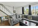 Spacious living room with sectional sofa, coffee table and large window at 8221 E Garfield St # L09, Scottsdale, AZ 85257