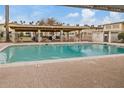 Community swimming pool with covered patio area and seating at 8221 E Garfield St # L09, Scottsdale, AZ 85257