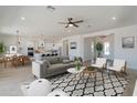 Open-concept living room with stylish furniture and decor, flowing seamlessly into the dining area at 4550 N 192Nd Dr, Litchfield Park, AZ 85340
