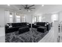 Open living area with sectional sofa, large rug, and view to dining area at 4636 E Tierra Buena Ln, Phoenix, AZ 85032