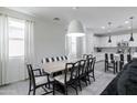 Dining area with black and white striped bench and adjacent kitchen at 4636 E Tierra Buena Ln, Phoenix, AZ 85032