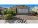 Single-story home with two-car garage and landscaped yard at 17879 W Hiddenview Dr, Goodyear, AZ 85338