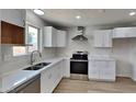Modern kitchen with white cabinets, stainless steel appliances, and quartz countertops at 887 W Shannon St, Chandler, AZ 85225