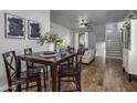 Cozy dining area with dark wood table and four chairs, near stairs and living room at 158 W Commerce Ct, Gilbert, AZ 85233