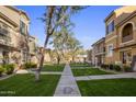 Inviting community courtyard with well-manicured lawns and walking paths at 158 W Commerce Ct, Gilbert, AZ 85233