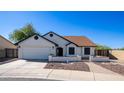 Single story home with a landscaped front yard and attached garage at 19624 N 47Th Ln, Glendale, AZ 85308