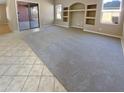 Spacious living room with tile and carpet flooring at 15818 W Mercer Ln, Surprise, AZ 85379