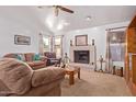 Living room featuring a fireplace and ample natural light at 2164 E Fairview Ave, Mesa, AZ 85204