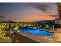 Stunning backyard oasis featuring a sparkling pool and mountain views at 20945 W Hillcrest Blvd, Buckeye, AZ 85396