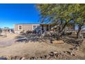 Mobile home exterior, showing front yard and landscaping at 2005 N 196Th Dr, Buckeye, AZ 85396