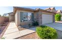 Side view of a one-story house with walkway to the entrance at 41547 W Cheyenne Ct, Maricopa, AZ 85138