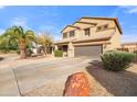 Two-story house with a large driveway and desert landscaping at 10468 W Palm Ln, Avondale, AZ 85392