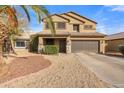 Two-story house with a landscaped front yard and double-car garage at 10468 W Palm Ln, Avondale, AZ 85392