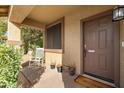 Covered porch with rocking chair and welcoming entryway at 10468 W Palm Ln, Avondale, AZ 85392