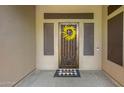 Elegant front door with decorative iron screen and wreath at 41619 N River Bend Rd, Anthem, AZ 85086